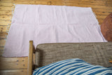 Handmade organic cotton pink and white rag rug with a subtle chevron pattern, 4x6.