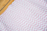 Subtle pink and white chevron pattern on an organic cotton rag rug.