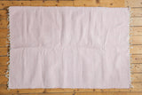 Organic cotton pink and white rag rug with subtle chevron design and fringe.