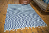 Navy and white zig-zag pattern of organic cotton rag rug with soft white fringe.