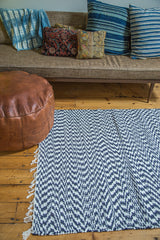 Handmade organic cotton navy and white rag rug featuring zigzag pattern and fringe.