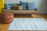 Minimalistic organic cotton rag rug, 4x6, with soft white and light gray woven texture.