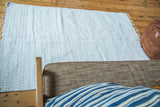 Soft, handwoven organic cotton rag rug texture in white and light gray.