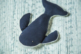 Close-up of organic cotton humpback whale stuffed animal, showing navy blue ribbed texture.