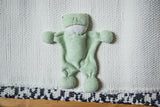 Organic cotton baby frog stuffed animal, soft light gray texture.