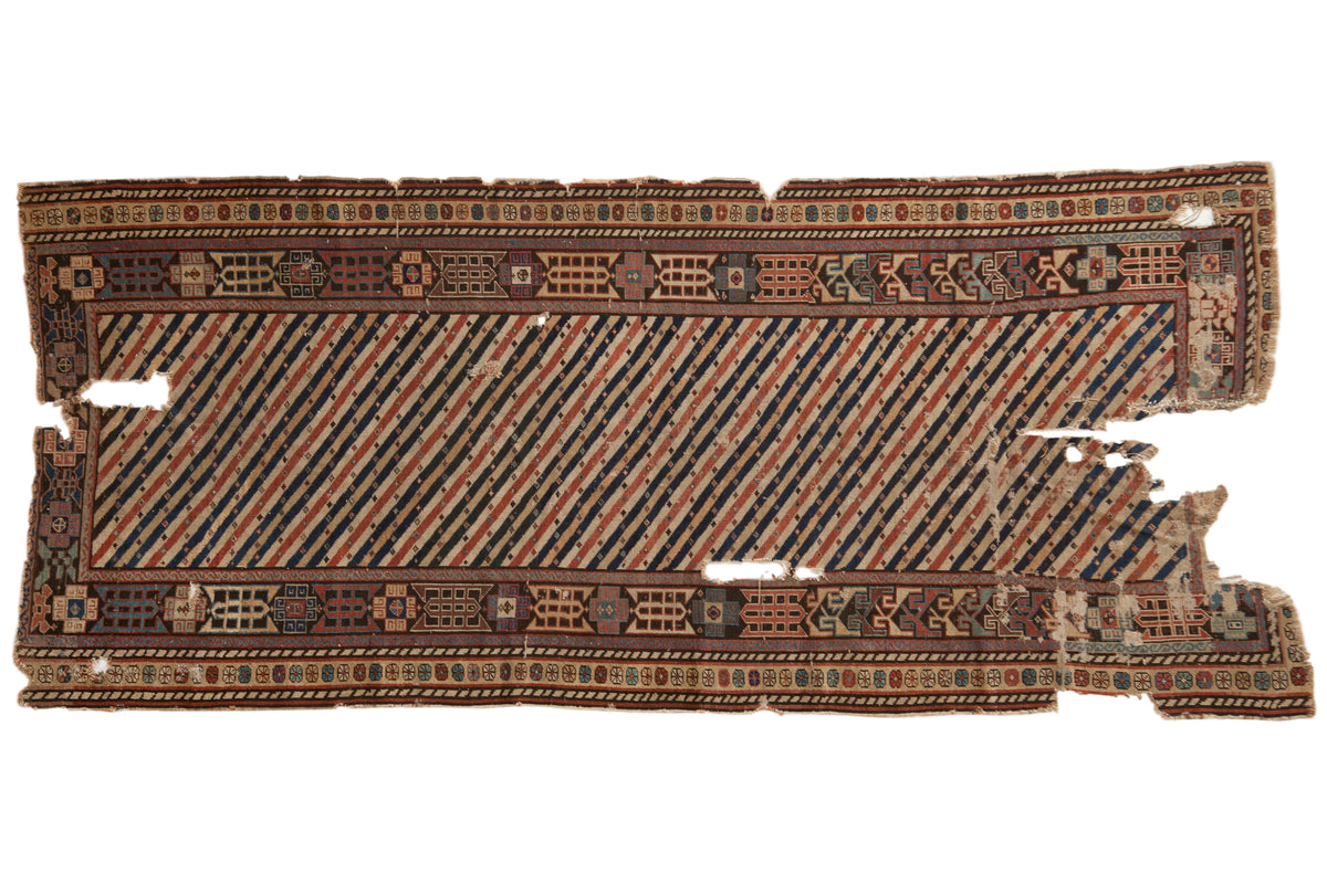 Antique Shirvan rug runner with bold diagonal stripes in rose, blue, and tan within a complex geometric border.