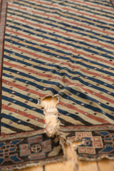 A tear on the antique Shirvan runner reveals its hand-spun wool and cotton foundation.