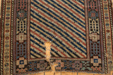 Detail of a large tear revealing the hand-spun cotton wefts on a distressed antique Shirvan rug.