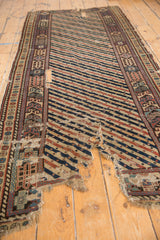Significant wear and tears on an antique Shirvan runner with a striped field and geometric border.