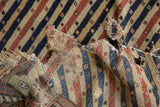 Exposed hand-spun cotton wefting and wool warps on a distressed antique Shirvan runner.