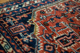Detailed hand-knotted pile of a vintage Hamadan rug, showing rust red, navy, ivory geometric patterns.