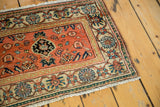 Vintage Malayer rug corner with peachy orange, ivory, blue, and mallard green motifs.