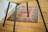 Vintage Malayer rug corner with peachy orange, ivory, blue, and mallard green borders.