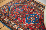 Cherry red field with Herati design and germinating flower border on this Borchalou Persian rug.