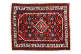 Vintage hand-knotted Engelas rug with cherry red field, central diamond medallion, and gem-tone florals.