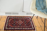 Cherry red field with rich floral motifs and diamond medallion on the vintage Engelas rug.