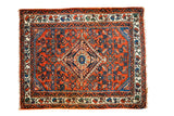 Vintage hand-knotted Engelas rug mat, rust red field, blue diamond medallion, ivory floral border.