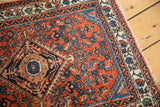Engelas rug mat's rust red field with diamond medallion and floral cross sections.