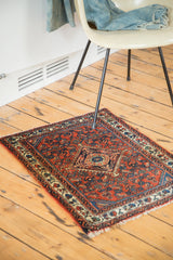 Engelas rug corner with gem-tone floral patterns, fringe, and a time-softened ivory border.