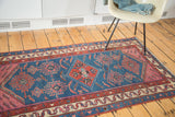 Detail of geometric, tribal patterns, stylized birds on indigo antique Malayer runner.