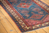 Finely woven antique Malayer rug corner, displaying an indigo tribal field and serpentine border.