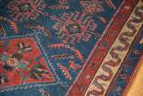 Antique Malayer rug detail, finely woven indigo field, red tribal motifs, serpentine border.