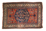 Antique Persian Bijar rug, circa 1915, with a large navy blue Herati medallion and madder red field.