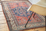 Antique Bijar rug detail, intricate Herati motif in navy field, bordered by ivory and rose patterns.