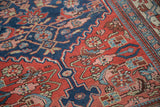 Antique Bijar rug detail: Herati pattern, madder red, navy, sky blue, muted green.