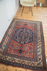 Lower corner of antique Bijar rug, showcasing intricate border and fringe.