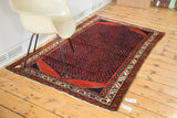 Hand-knotted 1940s Northwest Persian rug with a rich navy boteh field and rust red borders, 3'10