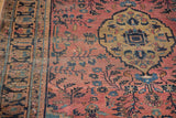 Distressed dusty raspberry field, blossoming florals, gold medallion and navy palmette border.