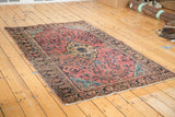 Distressed traditional Persian Sarouk rug, dusty raspberry field, navy palmette border.