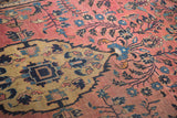 Distressed gold and teal inner corner spandrel on raspberry Sarouk field.
