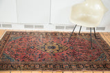 Vintage Sarouk rug corner, distressed dusty raspberry field and dark palmette border.