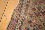 Purple patch and frayed fringe detail on the aged Belouch rug mat.