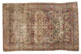 Antique Persian Kerman rug, oversized trefoil medallion, ornate milfleur field, muted red, blue, ivory.