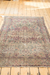 Antique Persian Kerman rug: ornate milfleur field, traditional border, and fringe.