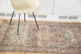 Ornate milfleur field with trefoil contours and a mellowed palette on an antique Kerman rug.
