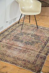 Antique Kerman rug featuring ornate trefoil medallion, germinating plants, and soft hues, circa 1900.