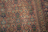 Antique Tabriz rug's allover herati motif, featuring softened brick rust, navy, and seafoam green.
