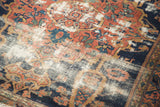 Worn madder red and navy field of antique Malayer rug with geometric pattern, showing foundation wear.