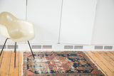Antique Malayer rug with distressed madder red and dark blue palette, showing wear to foundation.