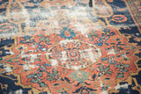Distressed madder root red medallion with bronze outline and geometric patterns on an antique Malayer rug.