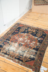 Authentic distressed aesthetic with foundation wear on the antique Persian Malayer rug.