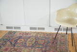 View of a vintage Lilihan rug with unique samovar and turtle motifs in blush, green, and blue.