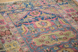 Vintage Lilihan rug featuring unique curvilinear samovar motif in blush, green, and saffron.