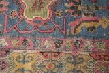 Traditional Persian Lilihan rug with vivid blush, green, and saffron yellow motifs.