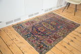Intricate green, saffron, and blush samovar/turtle motif on vintage hand-knotted Lilihan rug.