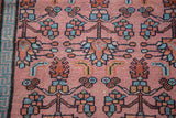Hand-knotted Malayer rug: dusty rose field, sky blue T-border, madder red and green floral motifs.